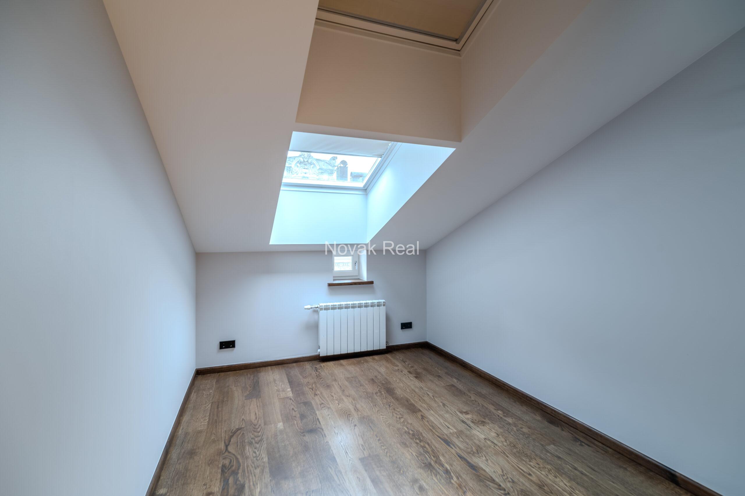 A spacious five-room attic apartment is offered for sale in the Quiet Centre of Riga