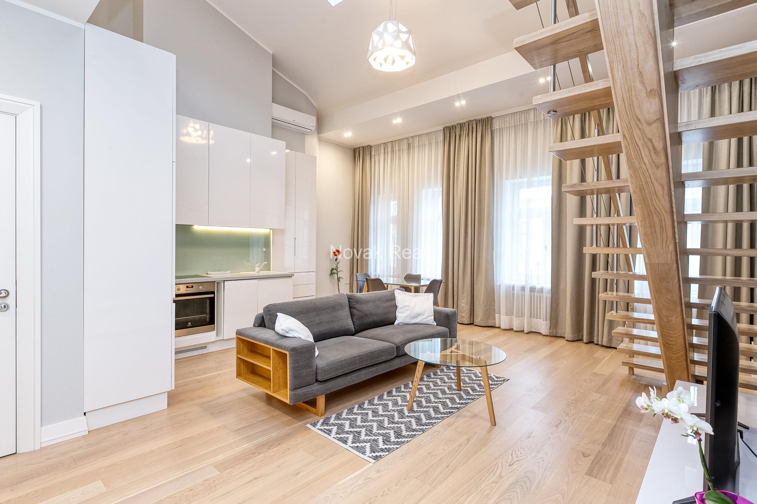 A duplex apartment is offered in the historic Résidence Lumière building