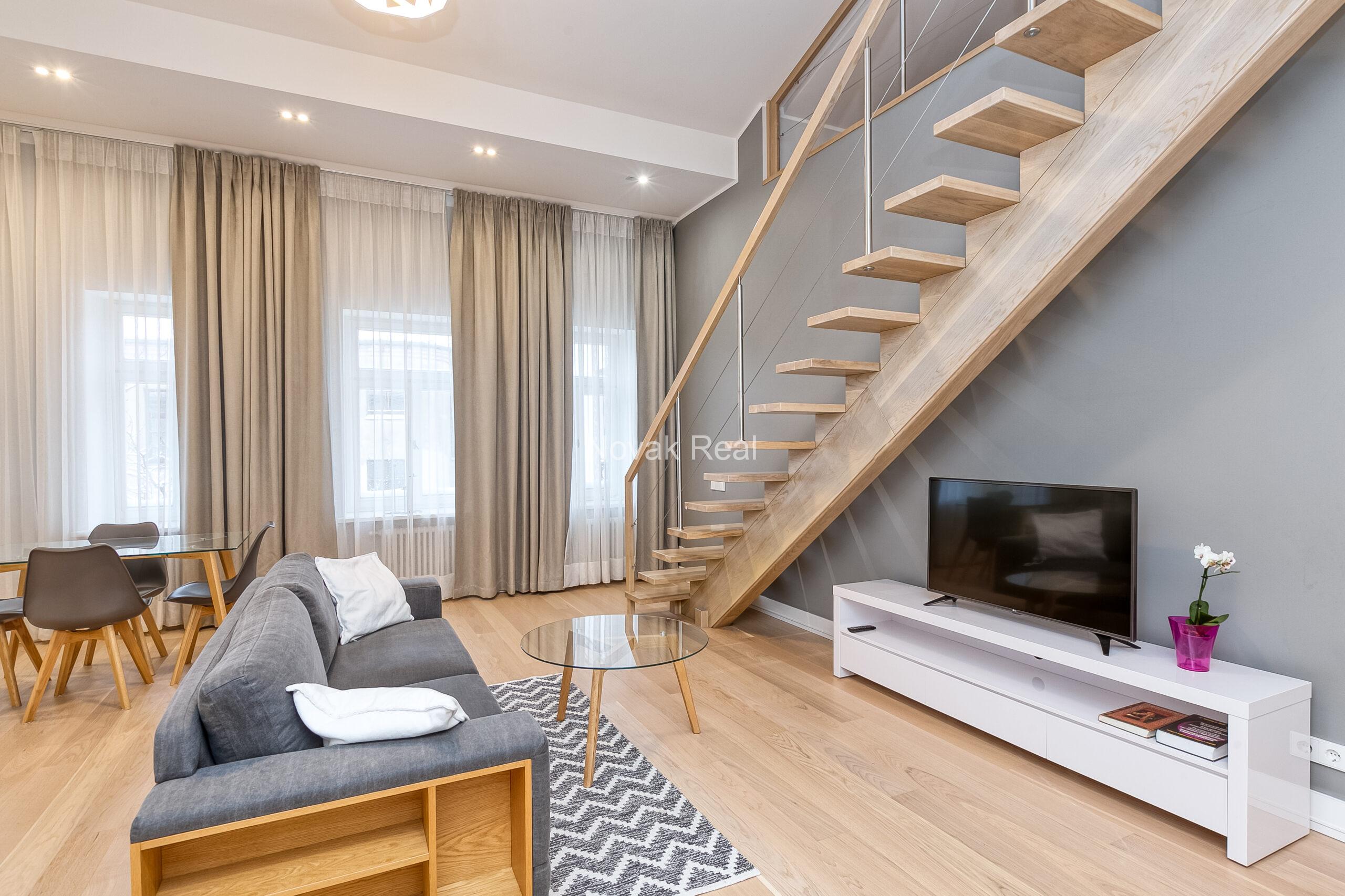 A duplex apartment is offered in the historic Résidence Lumière building