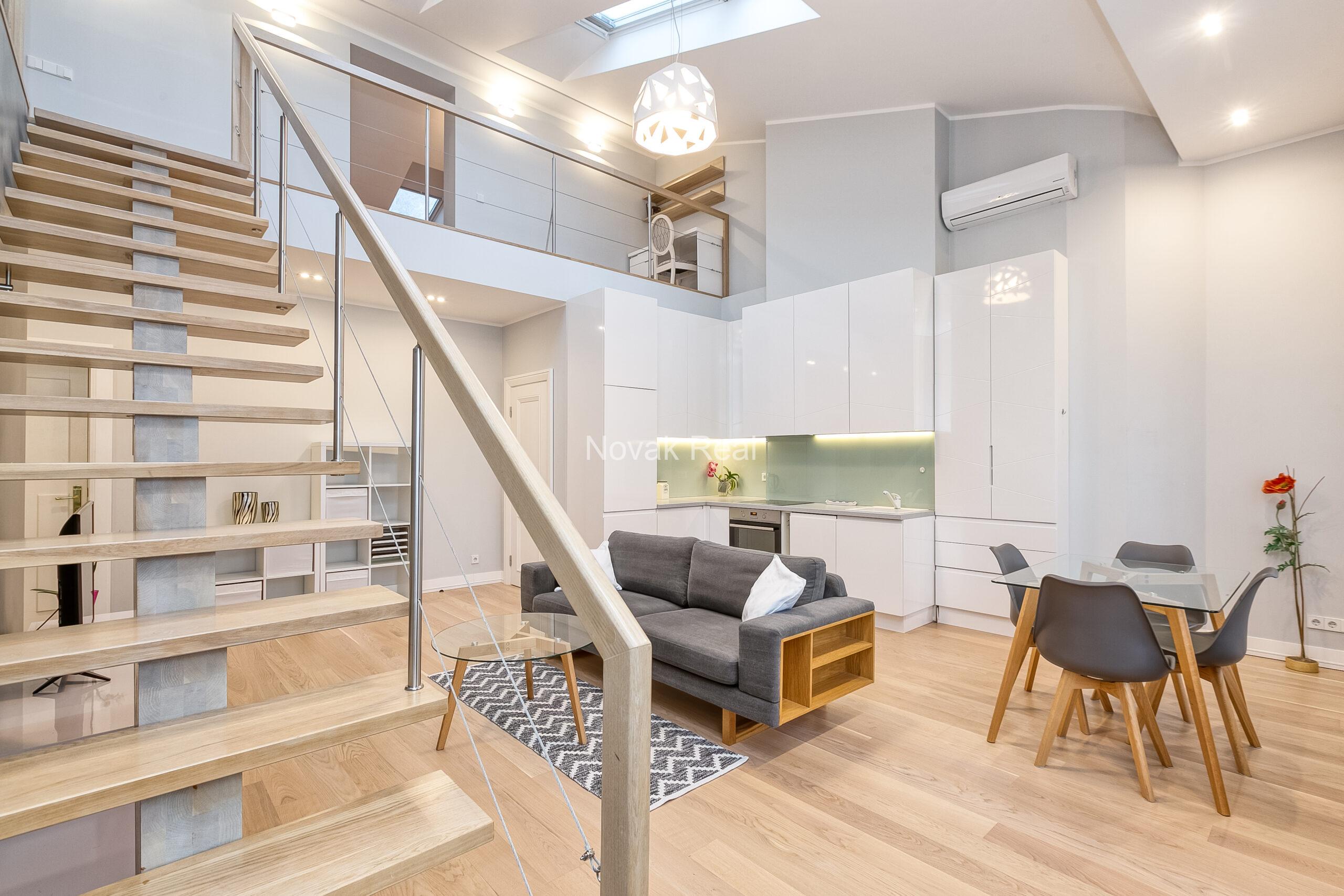 A duplex apartment is offered in the historic Résidence Lumière building