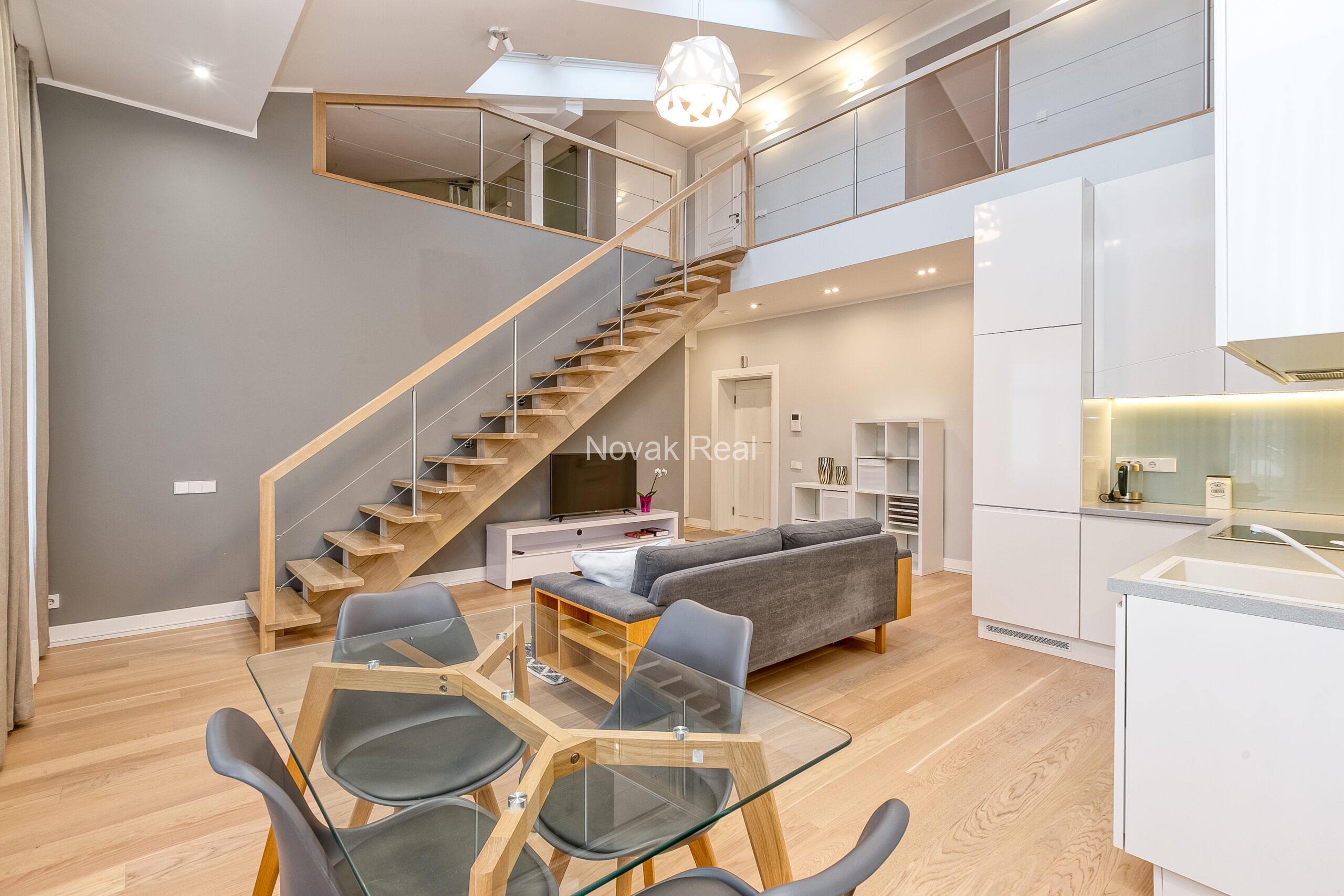 A duplex apartment is offered in the historic Résidence Lumière building