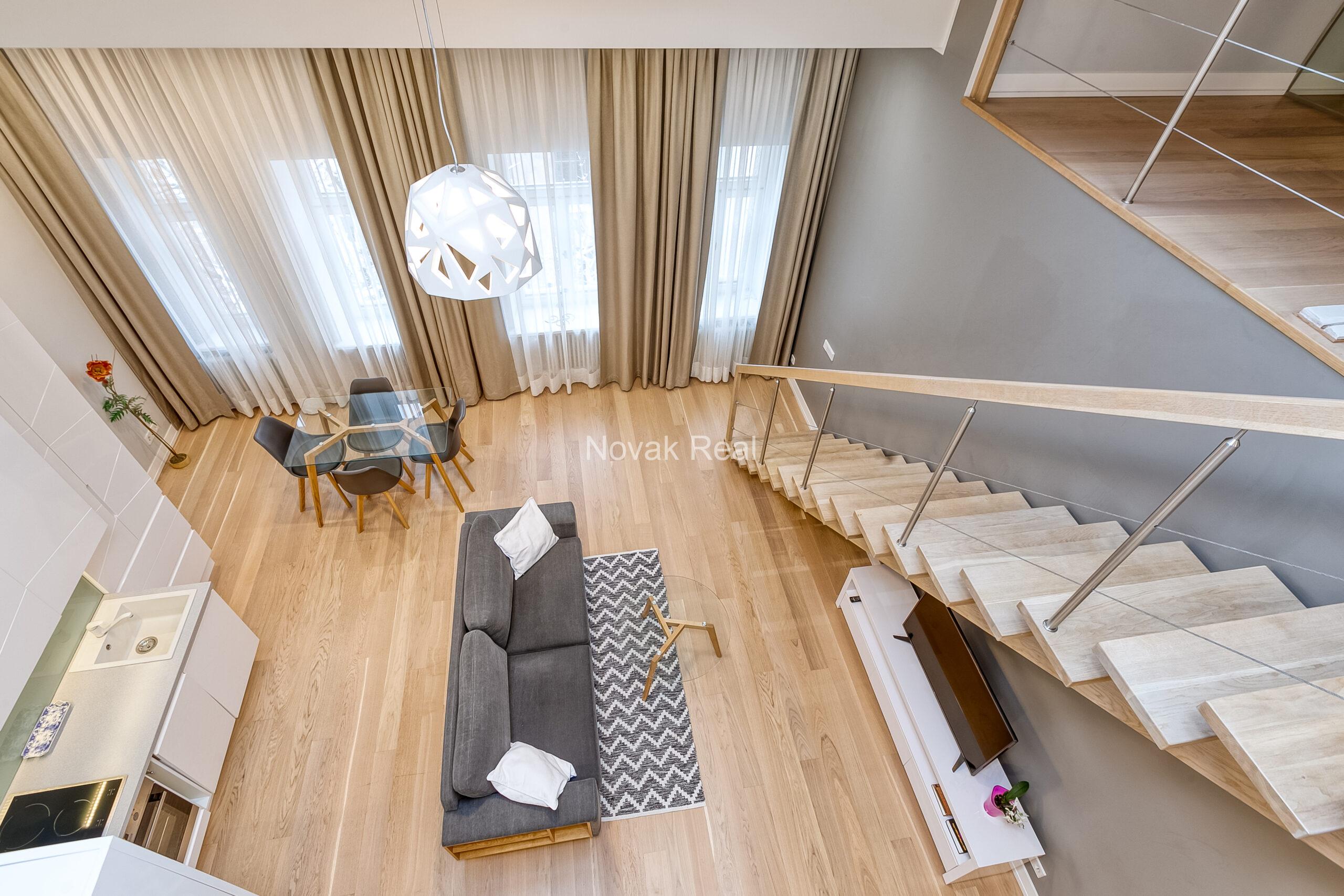 A duplex apartment is offered in the historic Résidence Lumière building