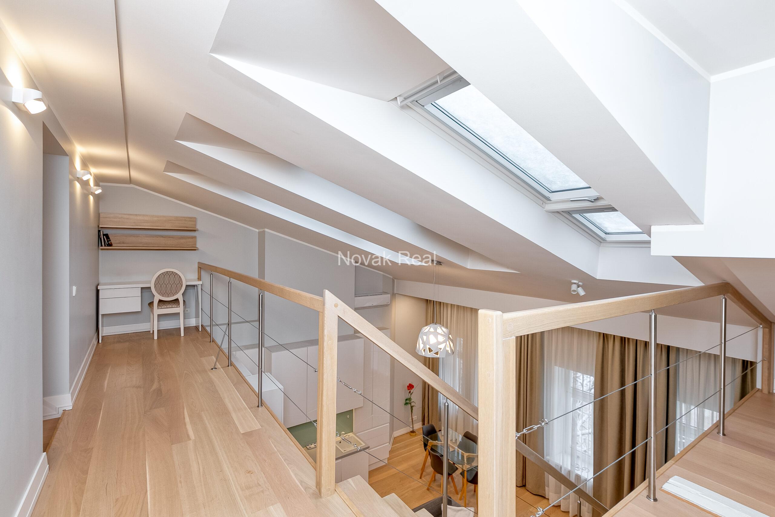 A duplex apartment is offered in the historic Résidence Lumière building